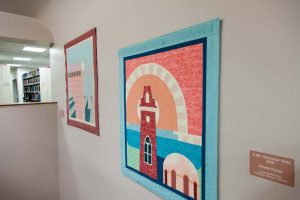 Photograph of quilts hanging on wall