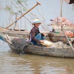 Fisherman sitting in riverboat, Cambodia