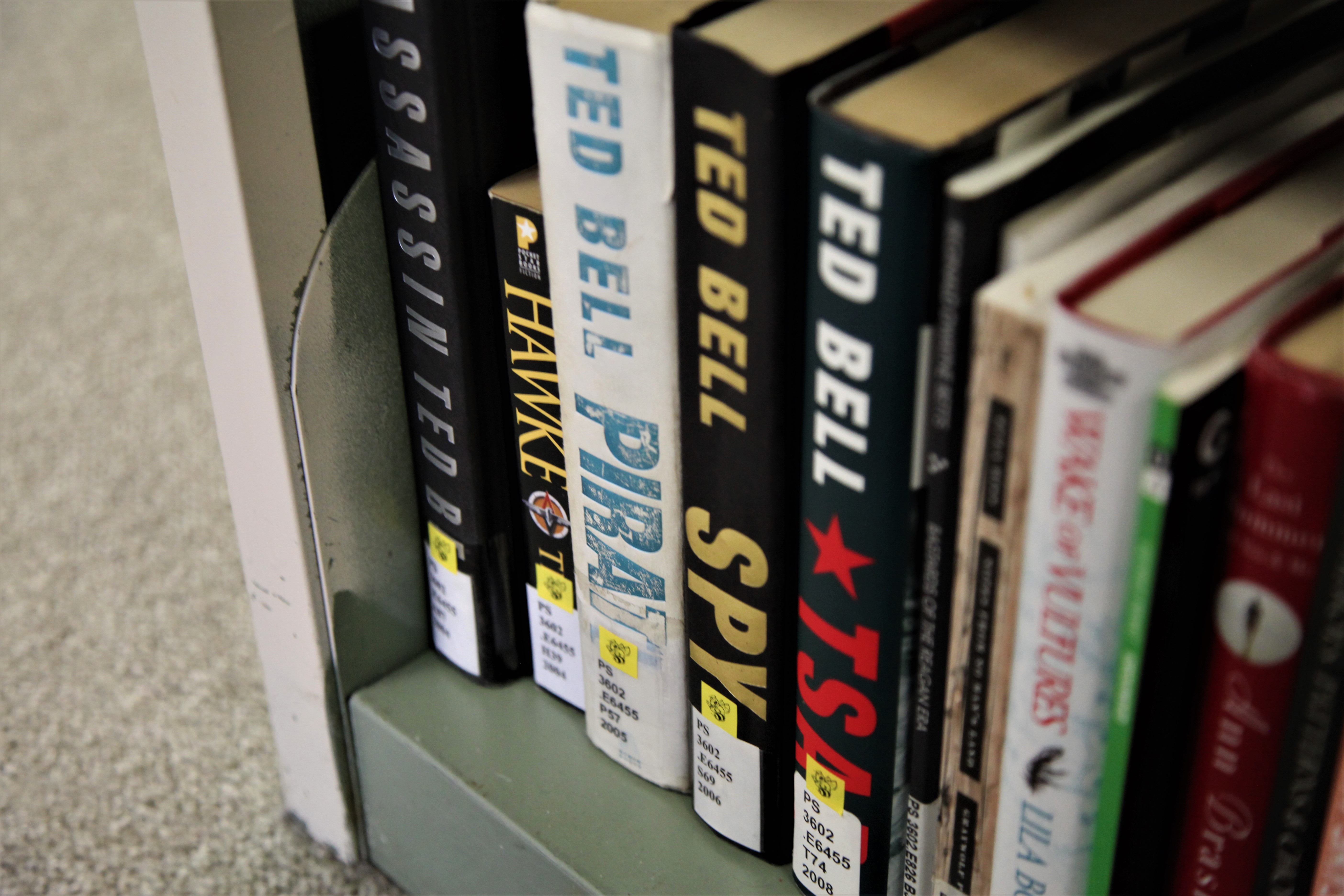 Yellow Jacket Stickers on books in the stacks.