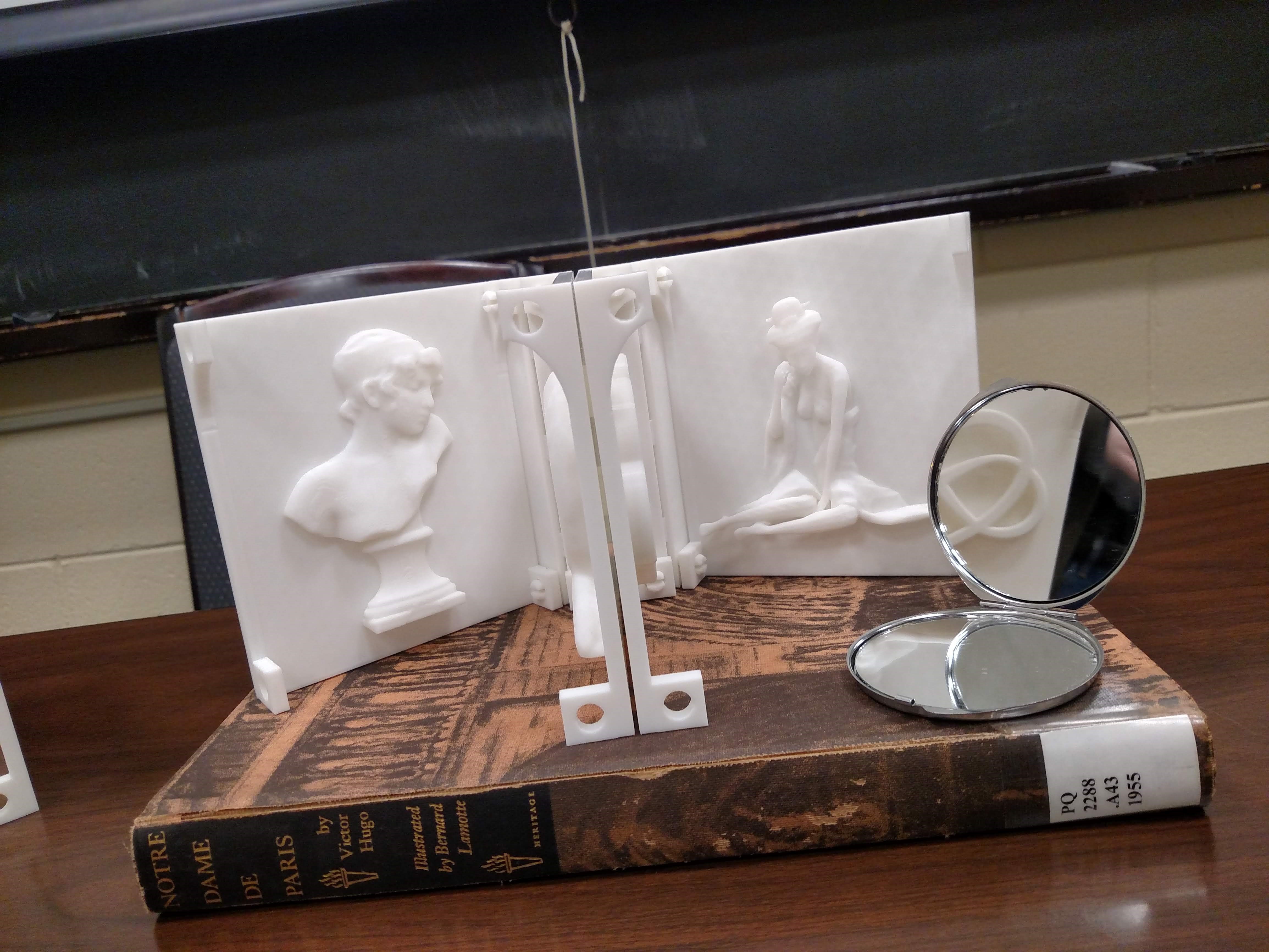 3D book and the book Notre Dame de Paris by Victor Hugo and a small round compact mirror